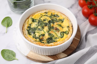 Photo of Delicious pie with spinach on white marble table, closeup