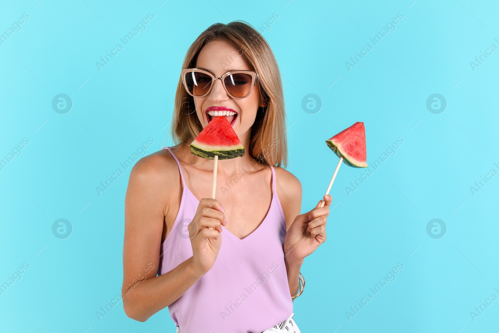 Photo of Pretty young woman with juicy watermelon on color background