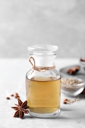 Anise essential oil and spice on light table