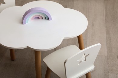 Photo of Small table and chairs in baby room, closeup