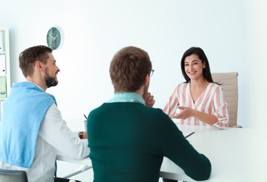 Photo of Human resources manager conducting job interview with applicants in office