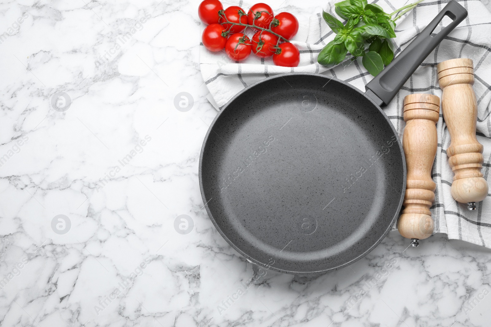 Photo of Flat lay composition with frying pan and fresh products on white marble table, space for text