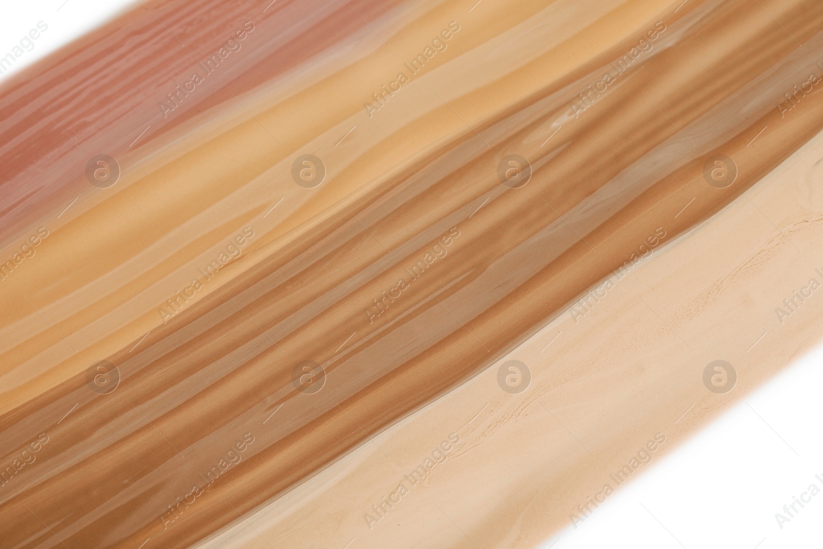 Image of Different shades of liquid foundation on white background, closeup