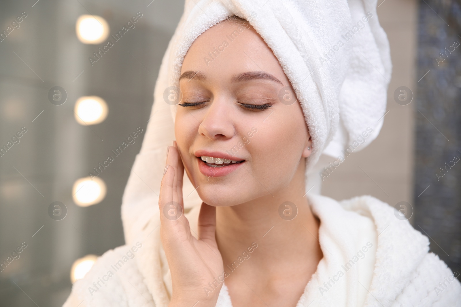 Photo of Portrait of beautiful woman with towel on head in bathroom