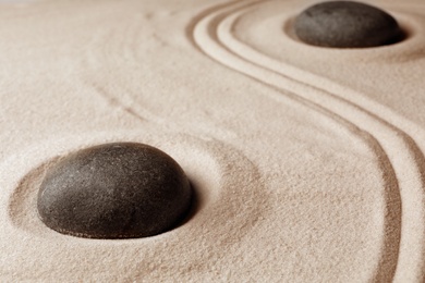 Zen garden stones on sand with pattern. Meditation and harmony