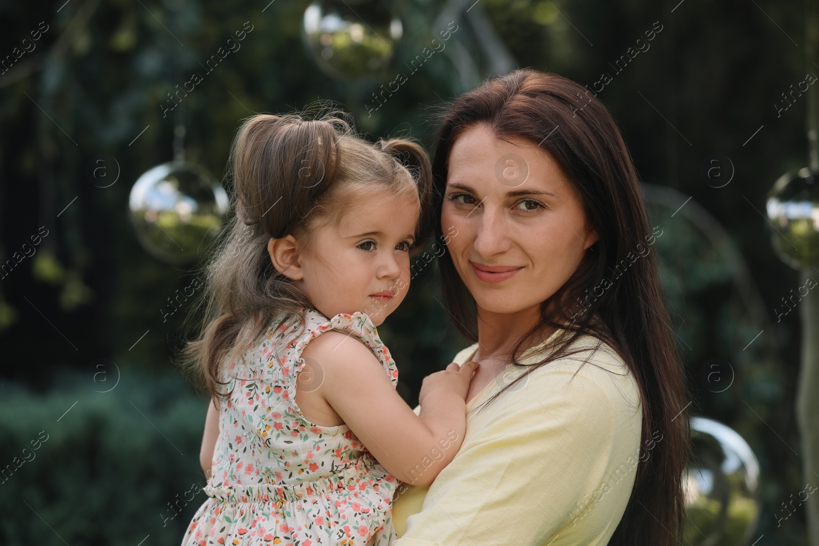 Photo of Portrait of happy mother with her cute daughter outdoors