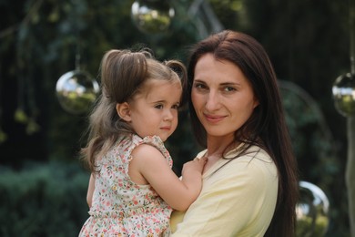 Photo of Portrait of happy mother with her cute daughter outdoors