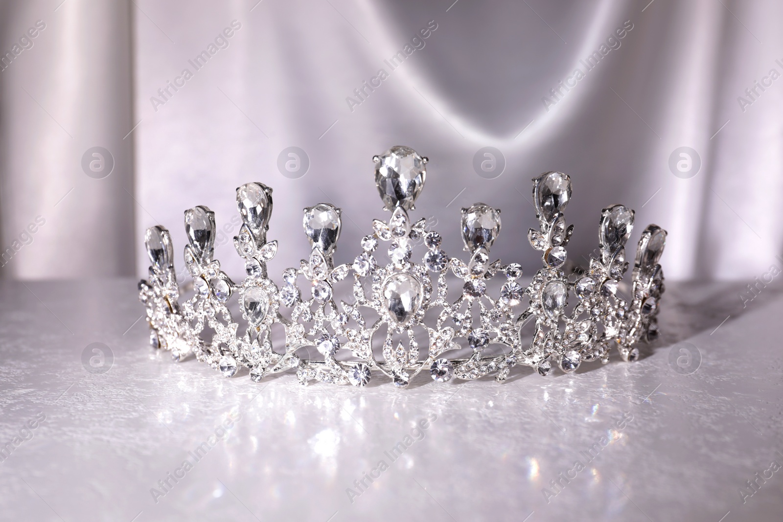 Photo of Beautiful silver tiara with diamonds on white table