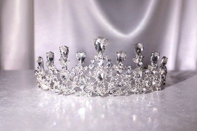 Photo of Beautiful silver tiara with diamonds on white table