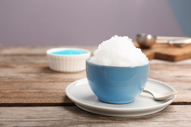 Photo of Bowl of tasty snow ice cream on wooden table. Space for text