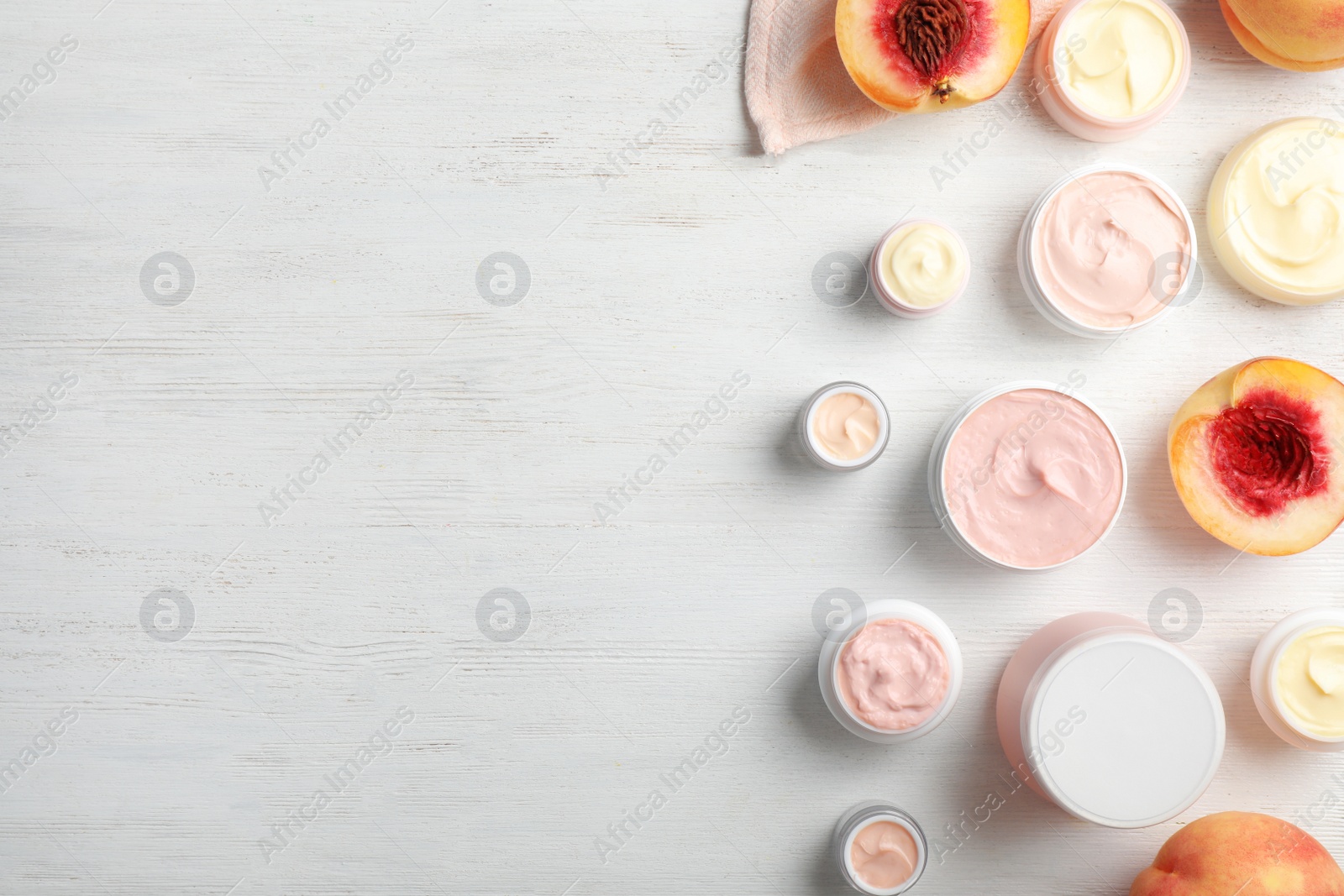 Photo of Flat lay composition with hand cream jars and space for text on wooden background