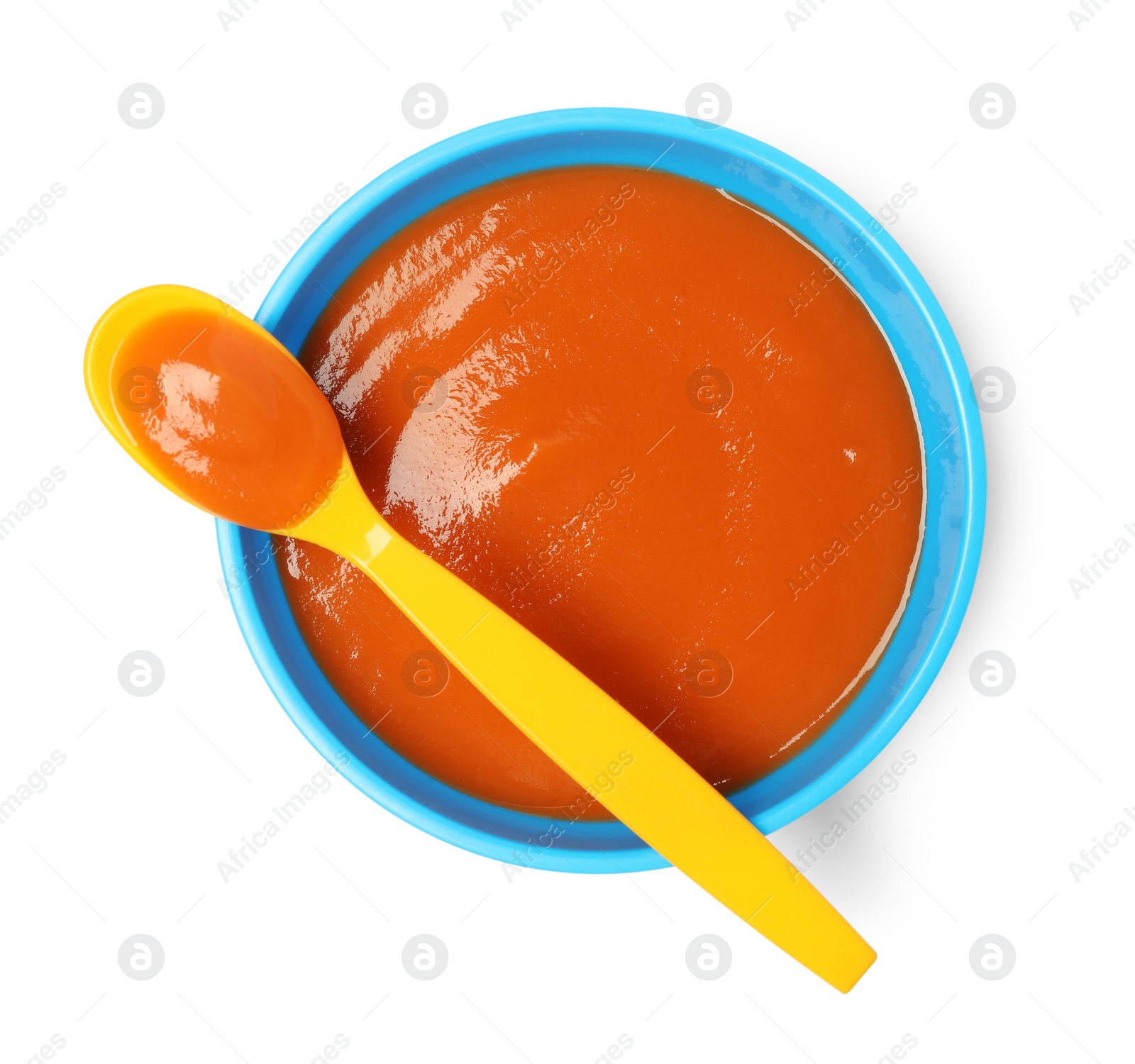 Photo of Delicious baby food in bowl and spoon isolated on white, top view