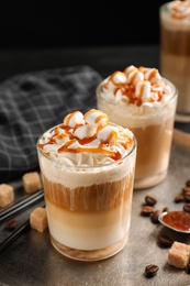 Photo of Glasses with delicious caramel frappe on tray