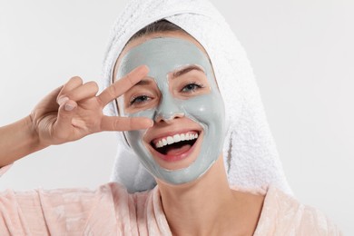 Photo of Woman with face mask on white background. Spa treatments