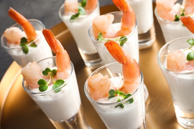 Photo of Glasses with boiled shrimps and sauce on tray