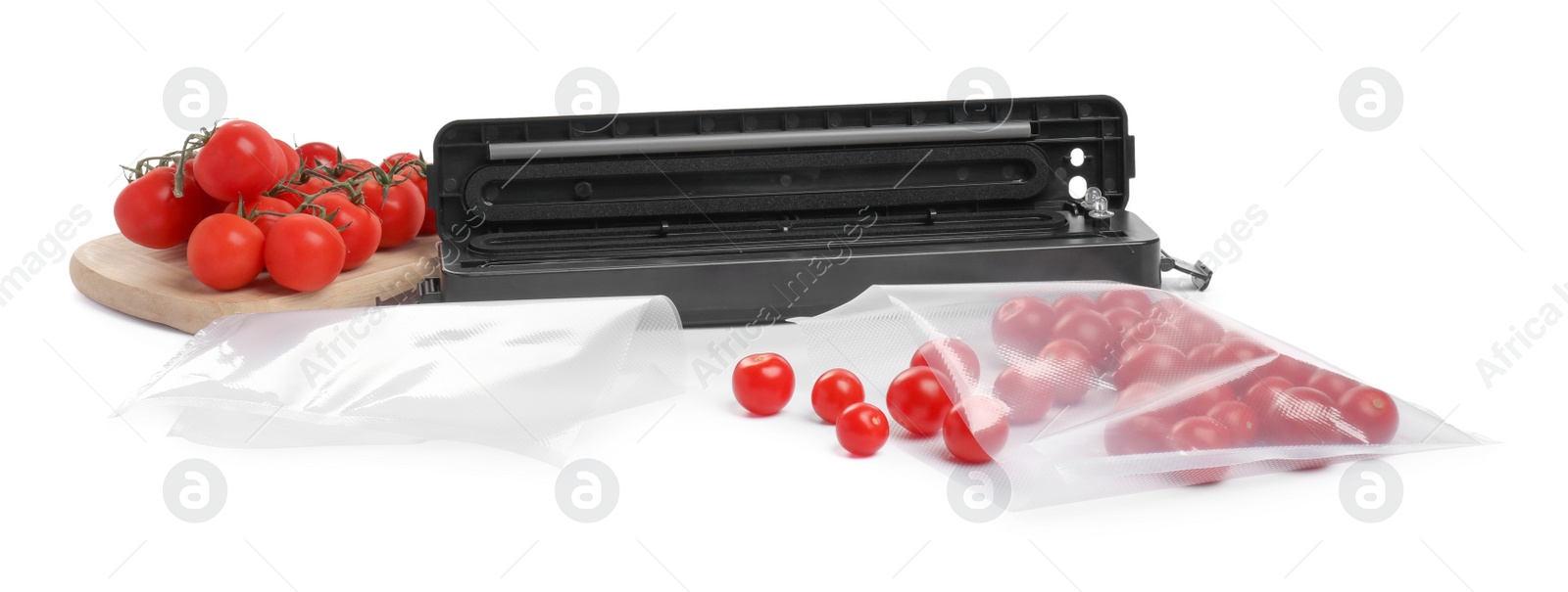 Photo of Sealer for vacuum packing with plastic bag of cherry tomatoes on white background