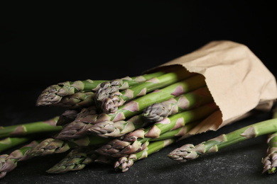 Fresh raw asparagus on black table, closeup