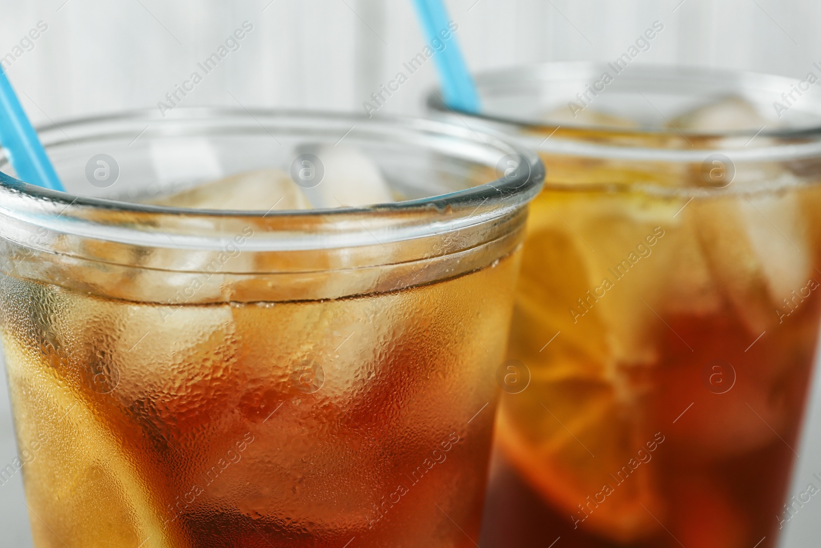 Photo of Glasses of delicious refreshing iced tea, closeup