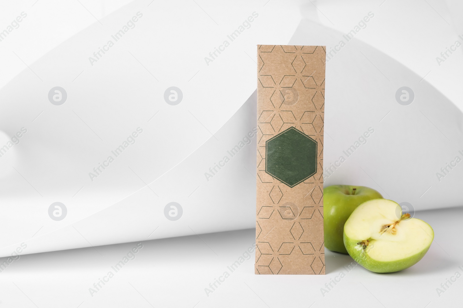 Photo of Scented sachet and apples on white background