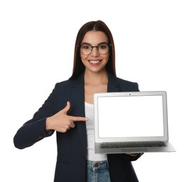 Young woman pointing at modern laptop on white background