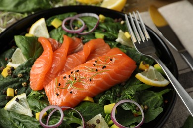 Photo of Delicious fresh salmon with spinach on plate, closeup