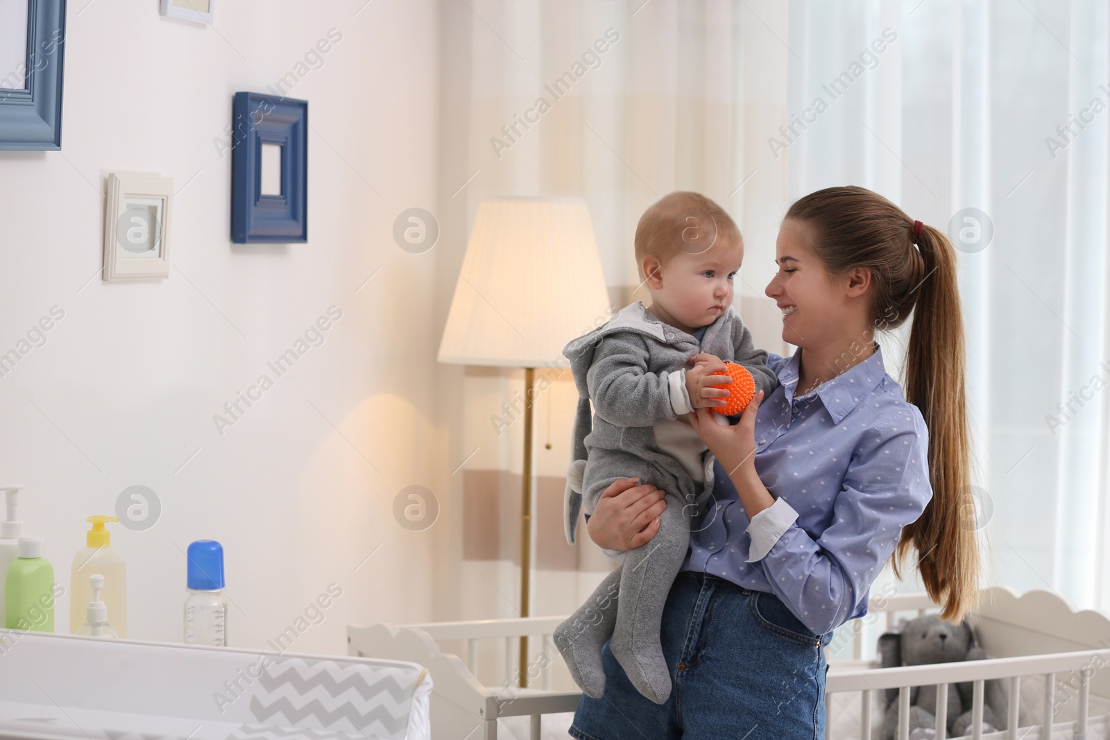 Photo of Teen nanny with cute little baby at home