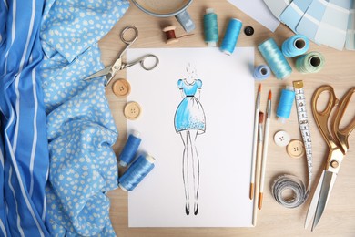 Photo of Sketch of fashion dress and thread supplies at designer's workplace, flat lay