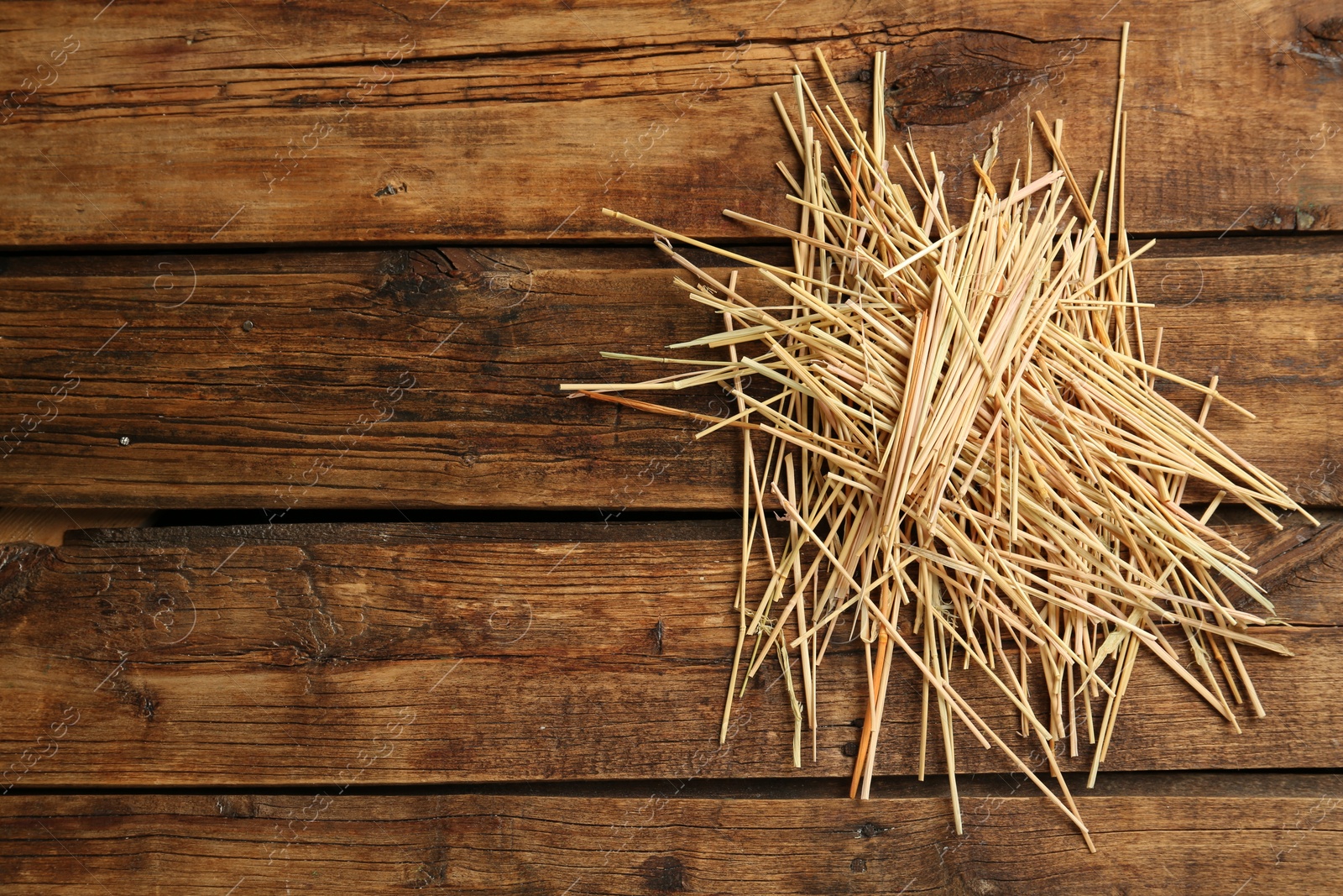 Photo of Dried hay on wooden background, top view. Space for text