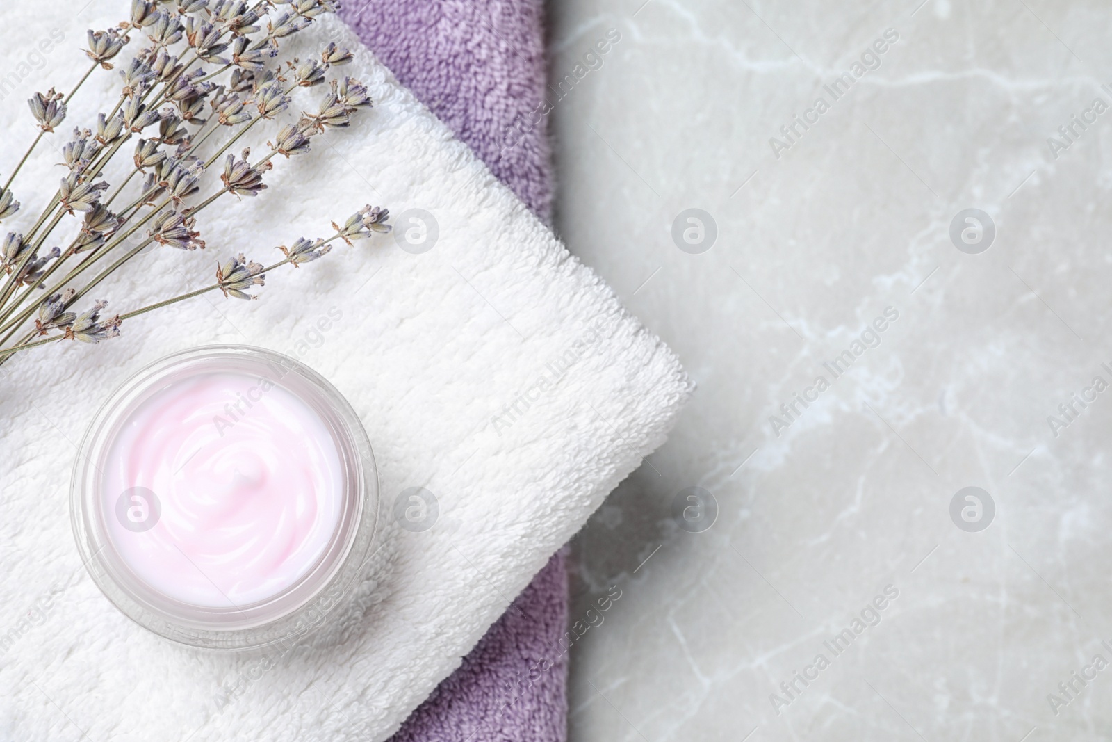 Photo of Flat lay composition with jar of cream on marble background. Space for text