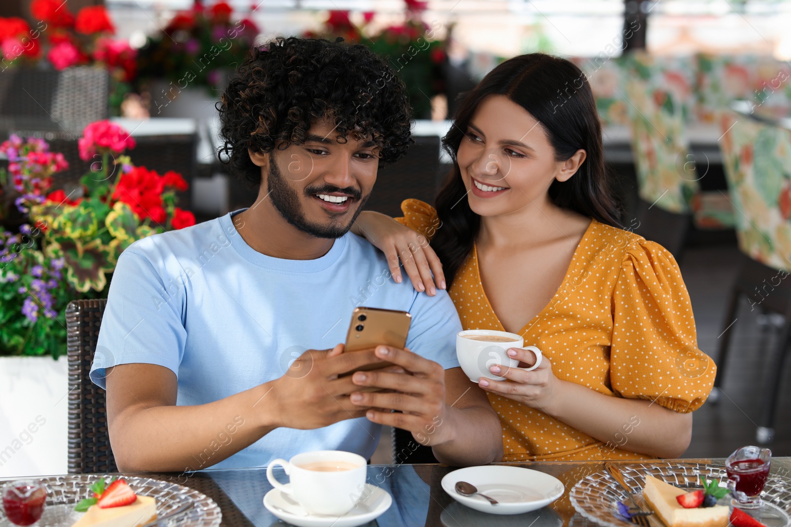 Photo of International dating. Happy couple spending time together in restaurant