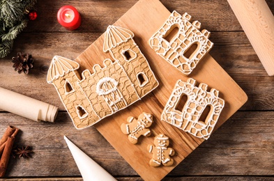 Flat lay composition with parts of gingerbread house on wooden table