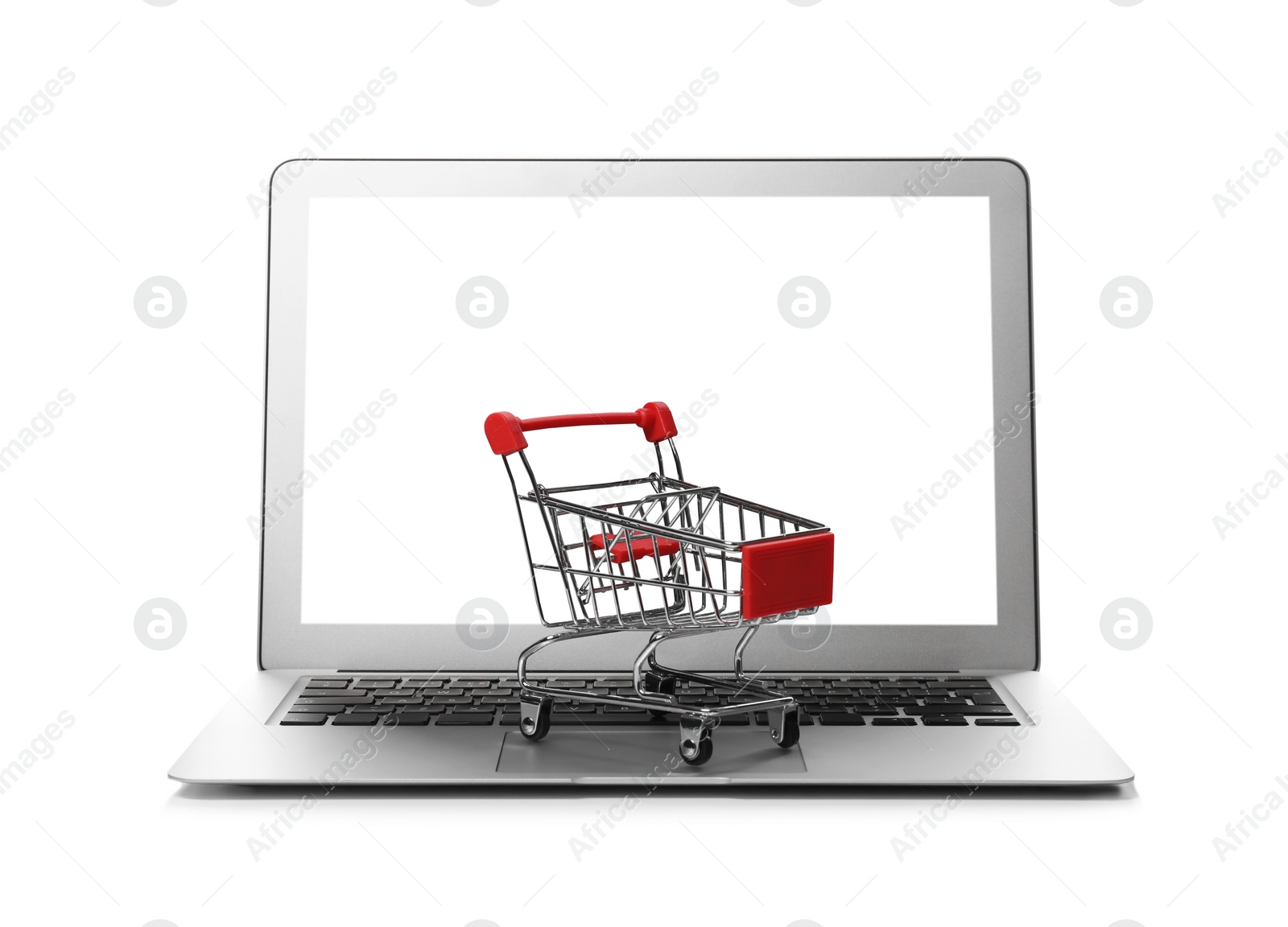 Photo of Internet shopping. Laptop with small cart isolated on white