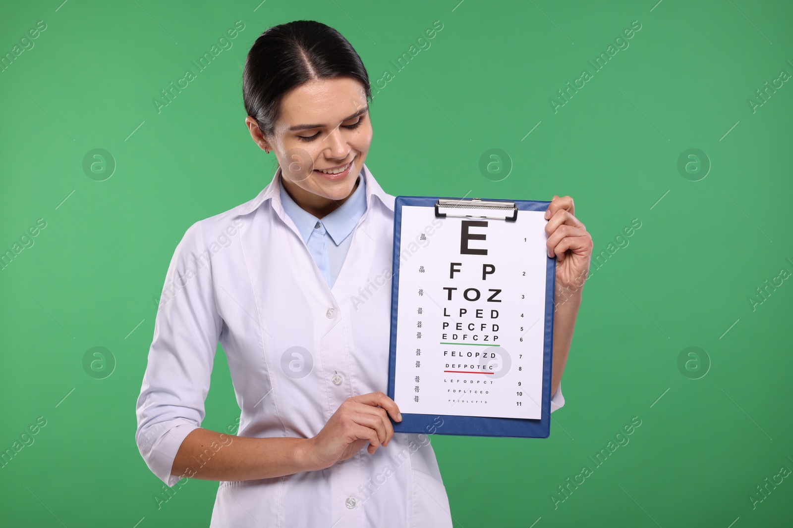 Photo of Ophthalmologist with vision test chart on green background