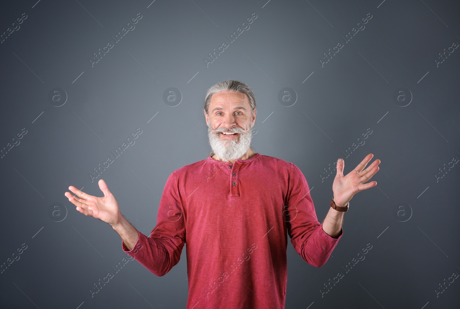 Photo of Portrait of handsome mature man on color background