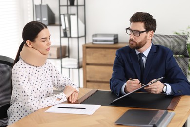 Photo of Injured woman having meeting with lawyer in office