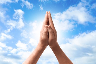 Image of Religion. Christian man praying against sky, closeup