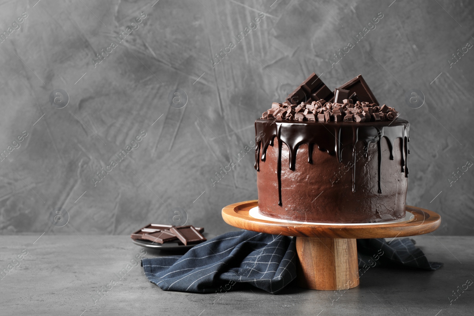 Photo of Freshly made delicious chocolate cake on grey table