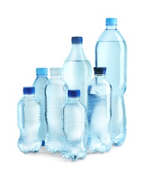 Set of different plastic bottles with water on white background