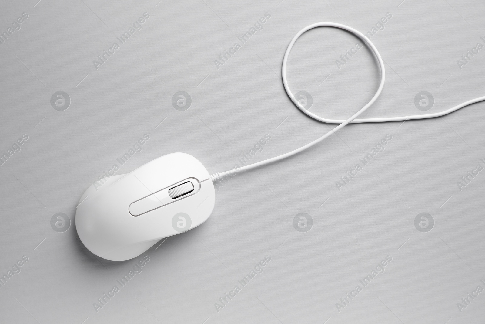 Photo of One wired mouse on grey background, top view