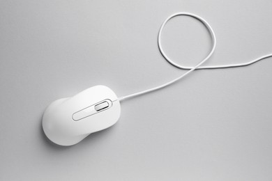 One wired mouse on grey background, top view