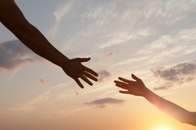 Photo of Man giving hand to woman outdoors, closeup. Help and support concept