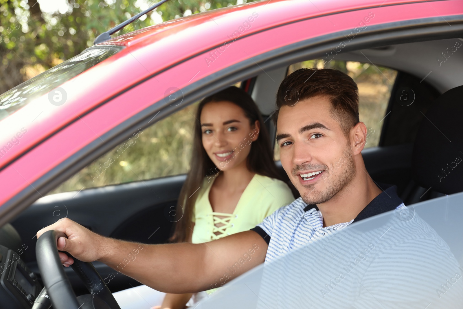 Photo of Happy young couple in car on road trip