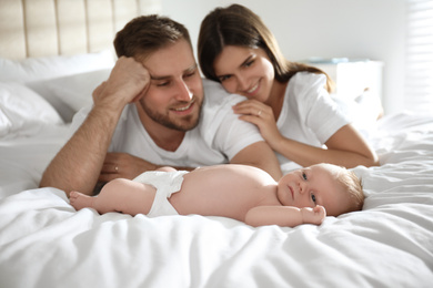 Happy couple with their newborn baby at home