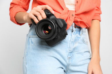 Photo of Professional photographer working on white background in studio, closeup