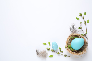 Flat lay composition with Easter eggs on white background. Space for text