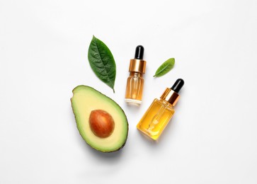 Photo of Flat lay composition with essential oil and avocado on white background