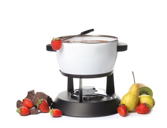 Photo of Chocolate fondue in pot and fresh fruits on white background