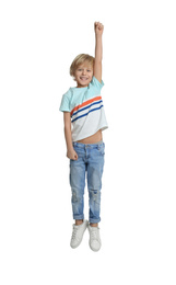 Happy little boy jumping on white background