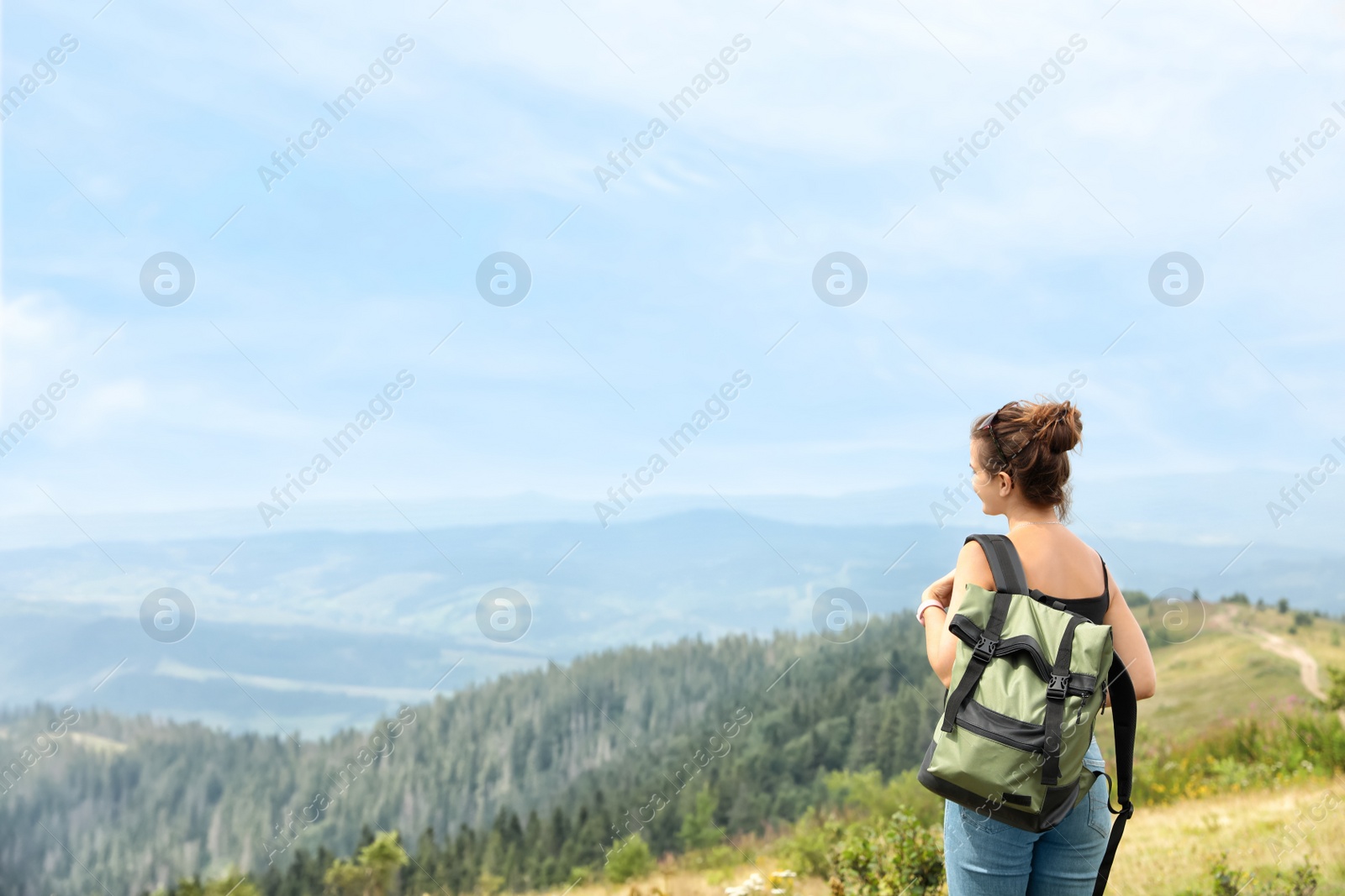 Photo of Woman with backpack in wilderness on cloudy day