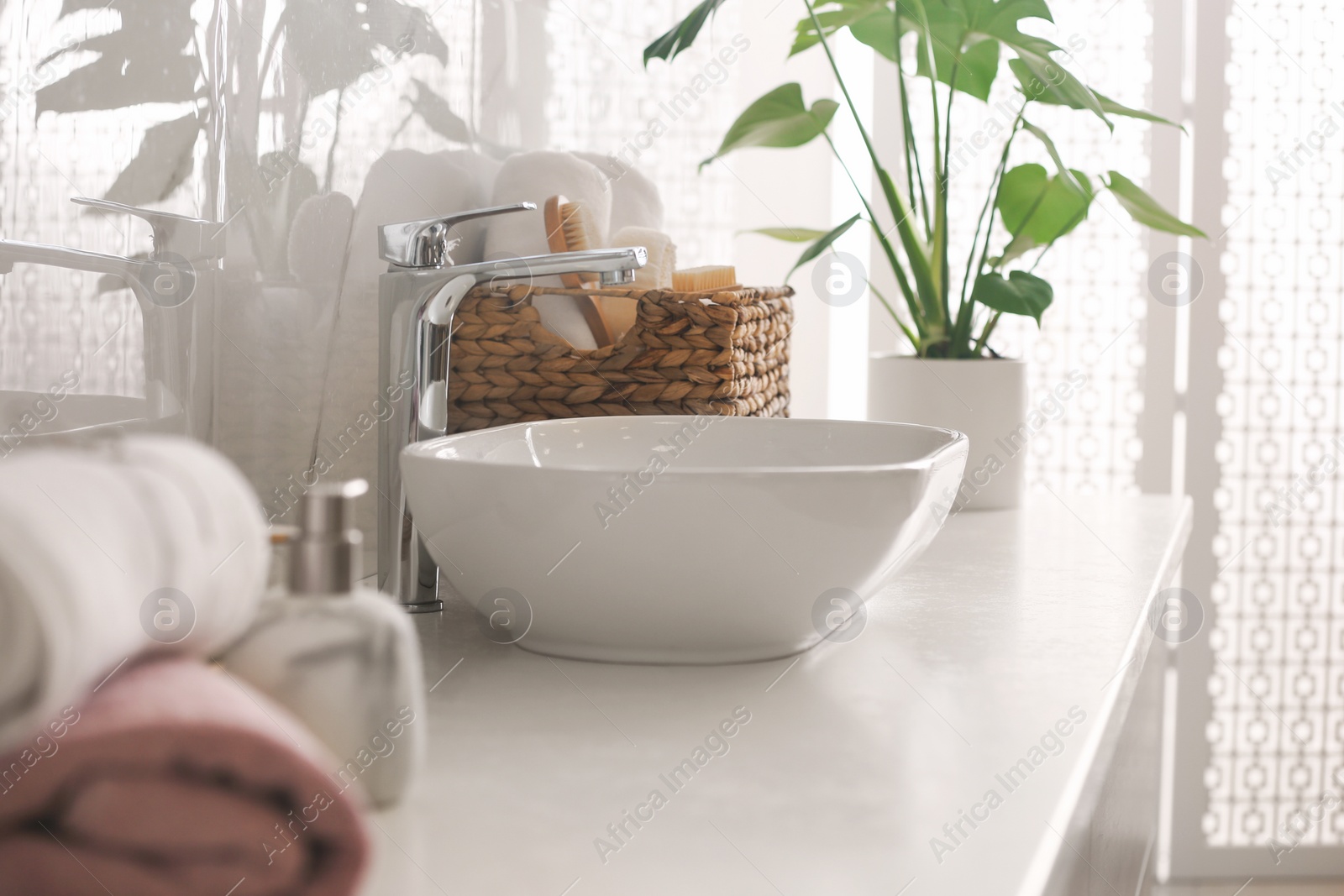 Photo of Stylish vessel sink on light countertop in modern bathroom